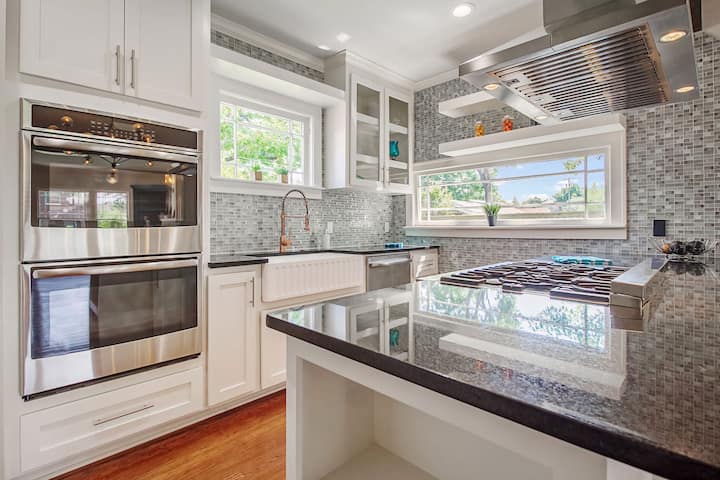 An image of a modern kitchen with sleek appliances, featuring a gas stove, refrigerator, and built-in microwave in Woodbridge